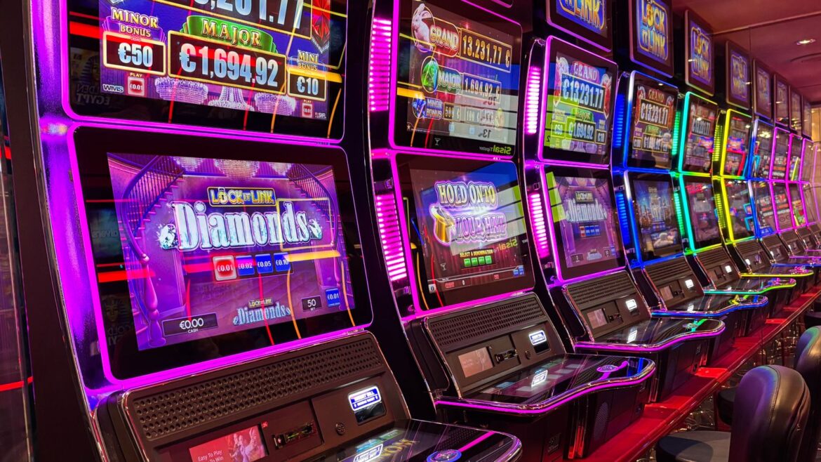 Machines à sous colorées alignées dans un casino avec néons et jackpots
